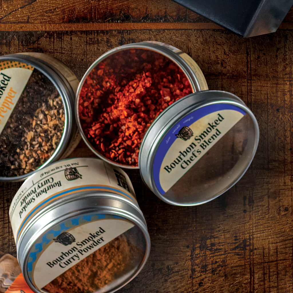 Tins of Bourbon Smoked Chef's Blend, Bourbon Smoked Curry Powder, and Bourbon Smoked Citrus Powder
