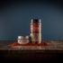 Bourbon Barrel Foods Bourbon Smoked Chili Powder in a shaker and a tin.