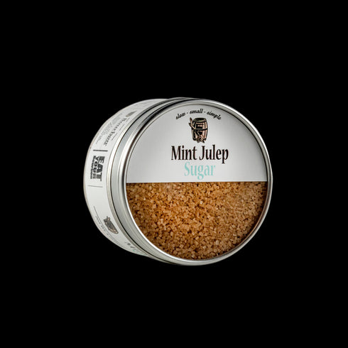 Bourbon barrel foods mint julep sugar is made with raw Demerara sugar and real spearmint. This is a photo of the tin at an angle so that you can see the sugar inside the can and the label.