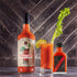 Bourbon Barrel Foods Bloody Mary cocktail mix in glass with hot sauce bottle