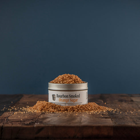 Bourbon Barrel Foods Bourbon Smoked Orange Sugar opened tin with sugar spilling over.
