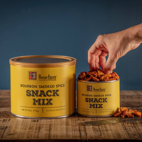 Bourbon Barrel Foods Bourbon Smoked Spice Snack Mix with hand and snack visual.