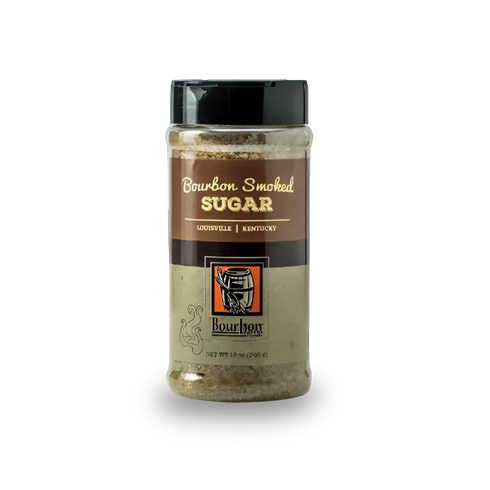 A clear plastic jar of Bourbon Smoked Sugar with a black lid and a brown and beige label, shown on a white background with a soft shadow.