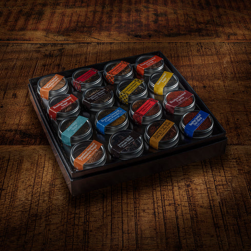 Set of small containers with Bourbon Smoked Spices and labels on a wooden surface