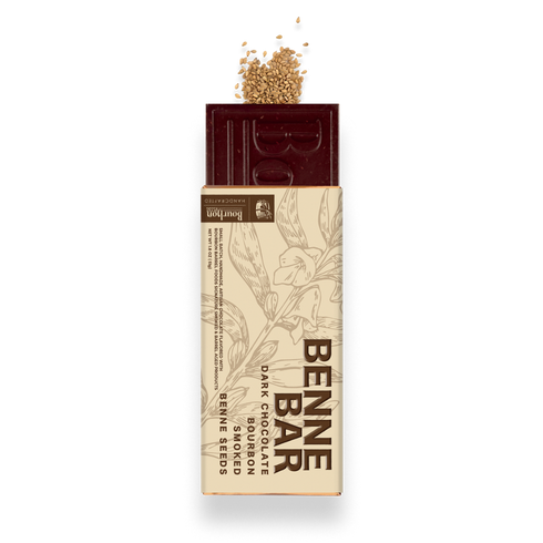 A Bennea dark chocolate bar with embedded seeds, shown with its beige paper wrapper and a small pile of seeds on top, isolated on a white background.