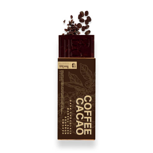 A Barbell Coffee Cacao chocolate bar in its brown paper wrapper, with dark cacao beans and cocoa powder spilling from the top, on a white background.