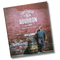 Book titled 'Eat Your Bourbon' with a Matt Jamie, Bourbon Barrel Foods founder and owner standing next to a barrel against a brick wall.