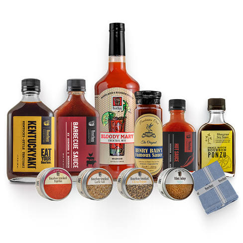 Collection of barbecue and hot sauce bottles with packaging on a white background