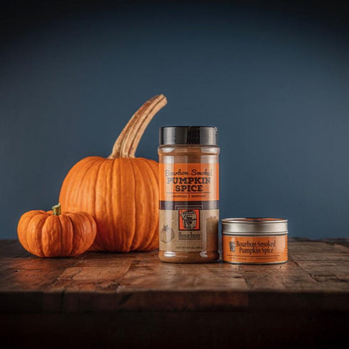 Bourbon Barrel Foods Bourbon Smoked Pumpkin Spice bottle and tin with pumpkins in the back.