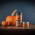 Bourbon Barrel Foods Bourbon Smoked Pumpkin Spice bottle and tin with pumpkins in the back.