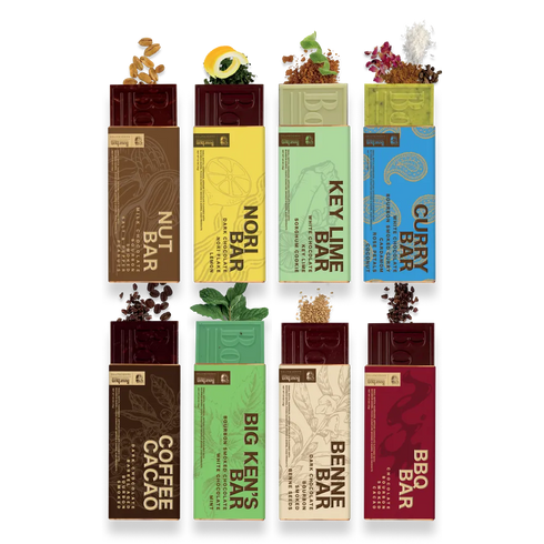 Eight gourmet chocolate bars arranged in a 2x4 grid on a white background, each with its packaging partially open to reveal toppings like nuts, fruit, and herbs. The bars include Nut Bar, Norbi Bar, Key Lime Bar, Cubby Bar, Coffee Cacao, Big Ken's Bar, Benne Bar, and BBQ Bar.