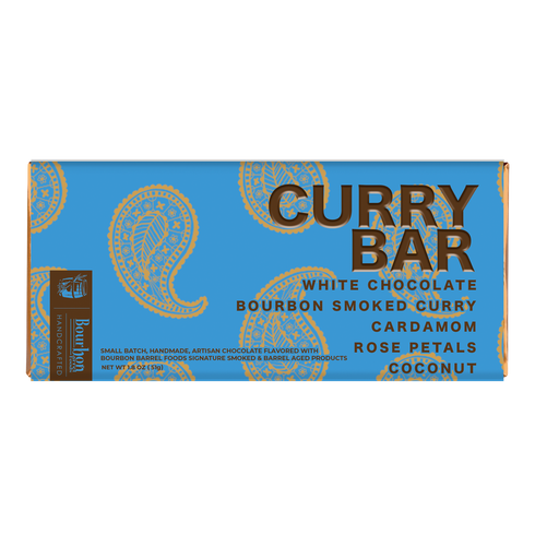 A rectangular blue chocolate bar package labeled 'CURRY BAR' with white and brown text, shown on a plain white background. The box includes flavor text: White Chocolate Bourbon Smoked Curry, Cardamom Rose Petals Coconut, and a vertical Bourbon Way Chocolate logo.