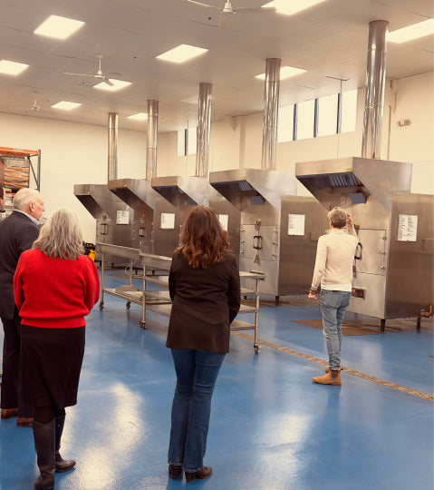 Matt Jamie showing a tour group the industrial smokers used for Bourbon Barrel Foods spices