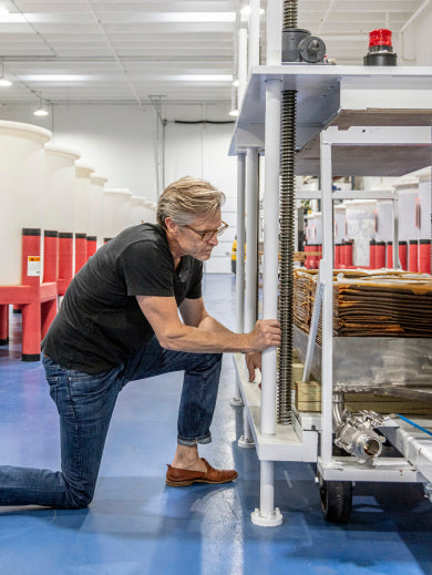 Matt Jamie inspecting soy sauce as it is being pressed