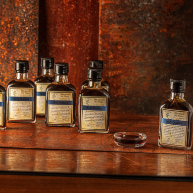 Several bottles of Bluegrass Soy Sauce, along with a small dish filled with the sauce