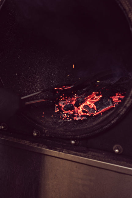 Close up photo of the bourbon barrel staves burning in a smoker