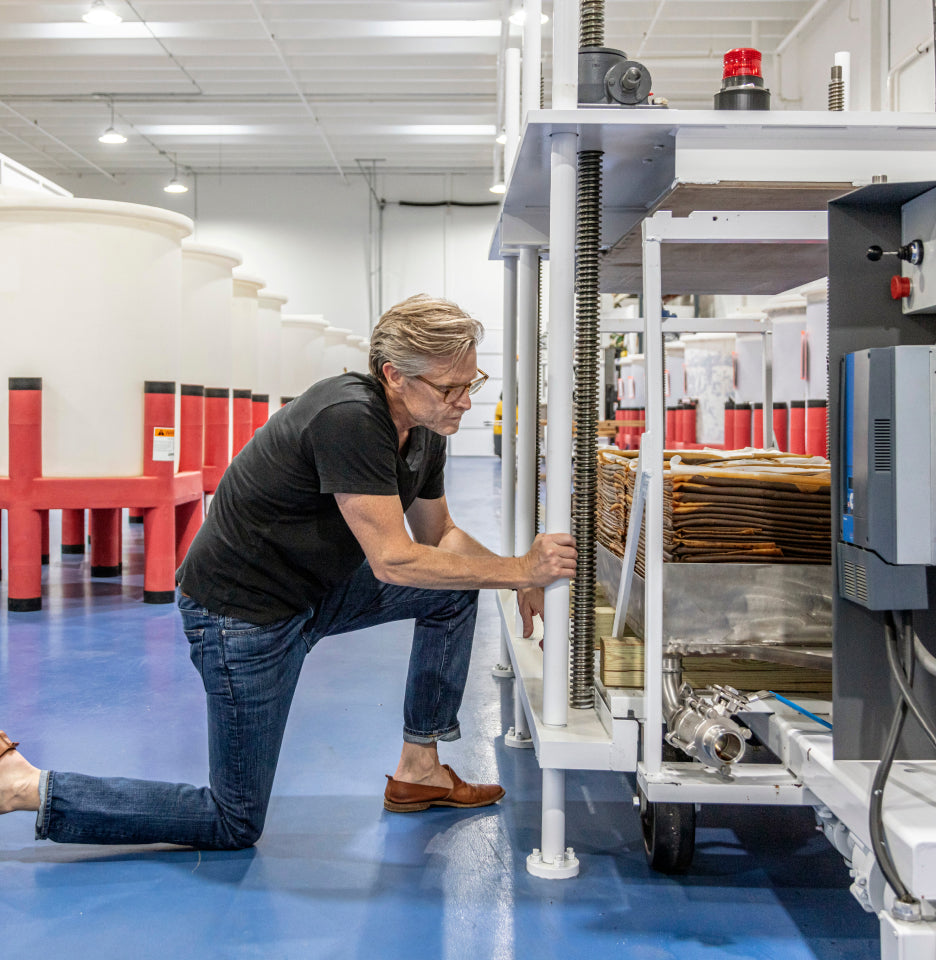 Matt Jamie inspecting soy sauce as it is being pressed
