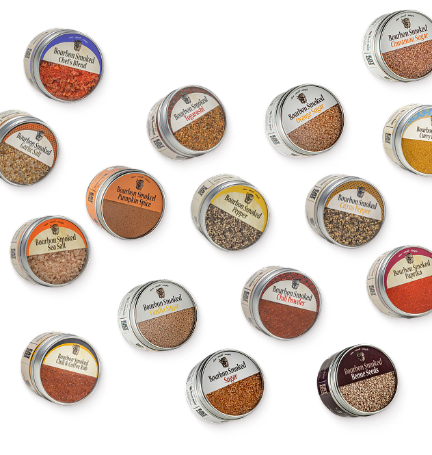 Bourbon Smoked Spice & Sugars Bundle: a collection of spice and sugar tins scattered on a cream background