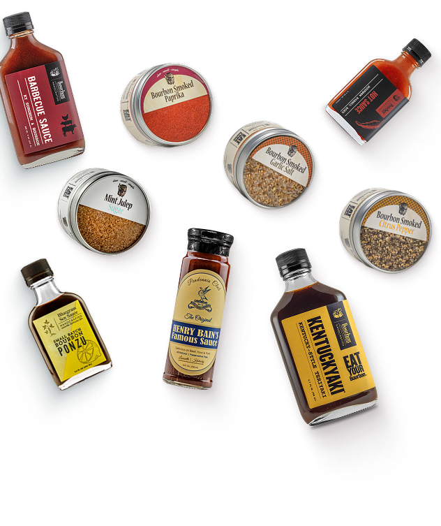 Kentucky Season Collection: smoked spices, barbecue sauce, and Kentuckyaki teriyaki sauce bottles scattered on a cream background