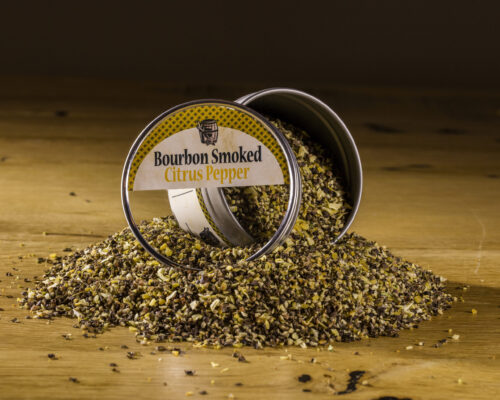 Bourbon Smoked Citrus Pepper open tin on pile of spices