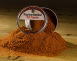 Bourbon Smoked Chili Powder open tin on pile of spices