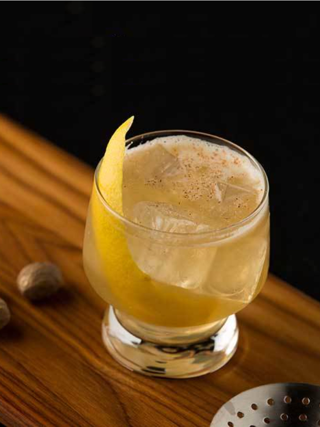 Traditional punch cocktail with lemon peel