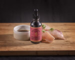 Bourbon Smoked Bluegrass Soy Sauce with plate of sushi