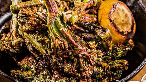 Bourbon Barrel Foods Ponzu Broccoli in a bowl in front of spices