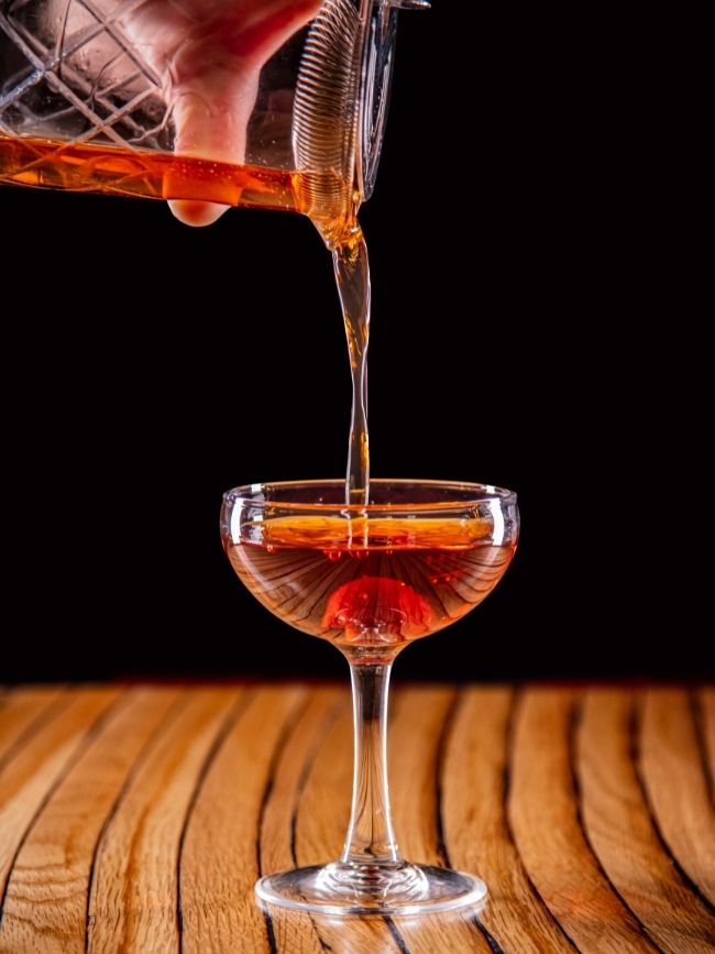Photo of a cocktail being poured into a glass