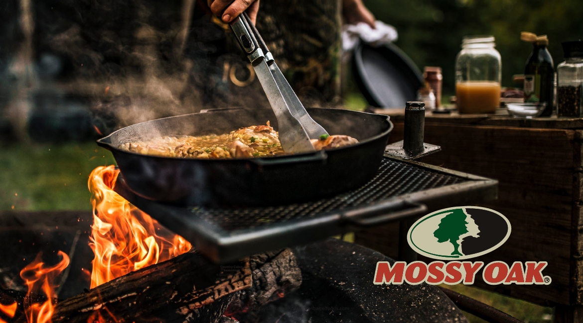 Mossy Oak Seasoning Partnership with Bourbon Barrel Foods - Mossy Oak Logo and cooking on live fire in the background.