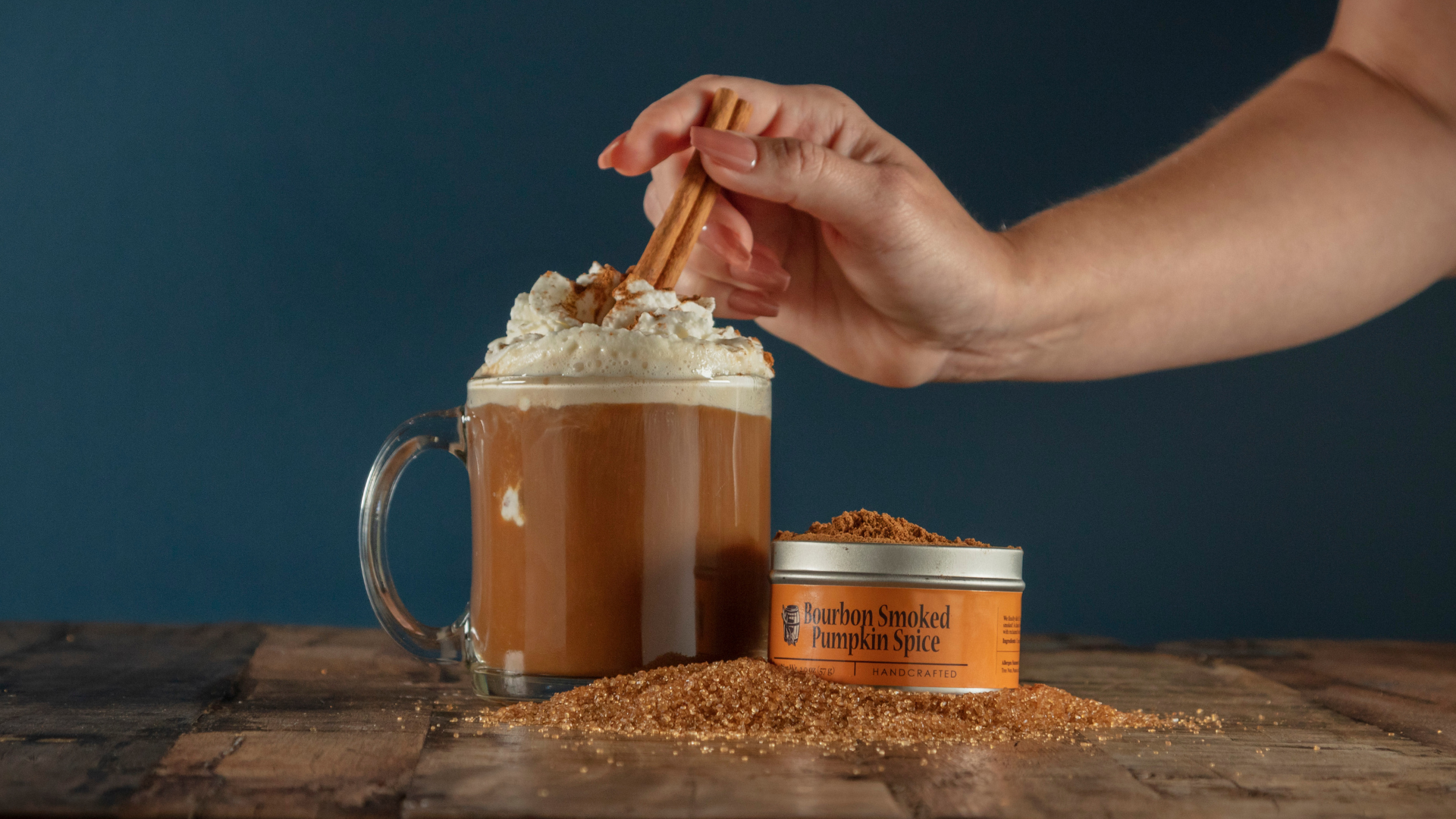 Bourbon Barrel Foods Bourbon Smoked Pumpkin Spice Latte with whipped cream and a cinnamon stick garnish. 